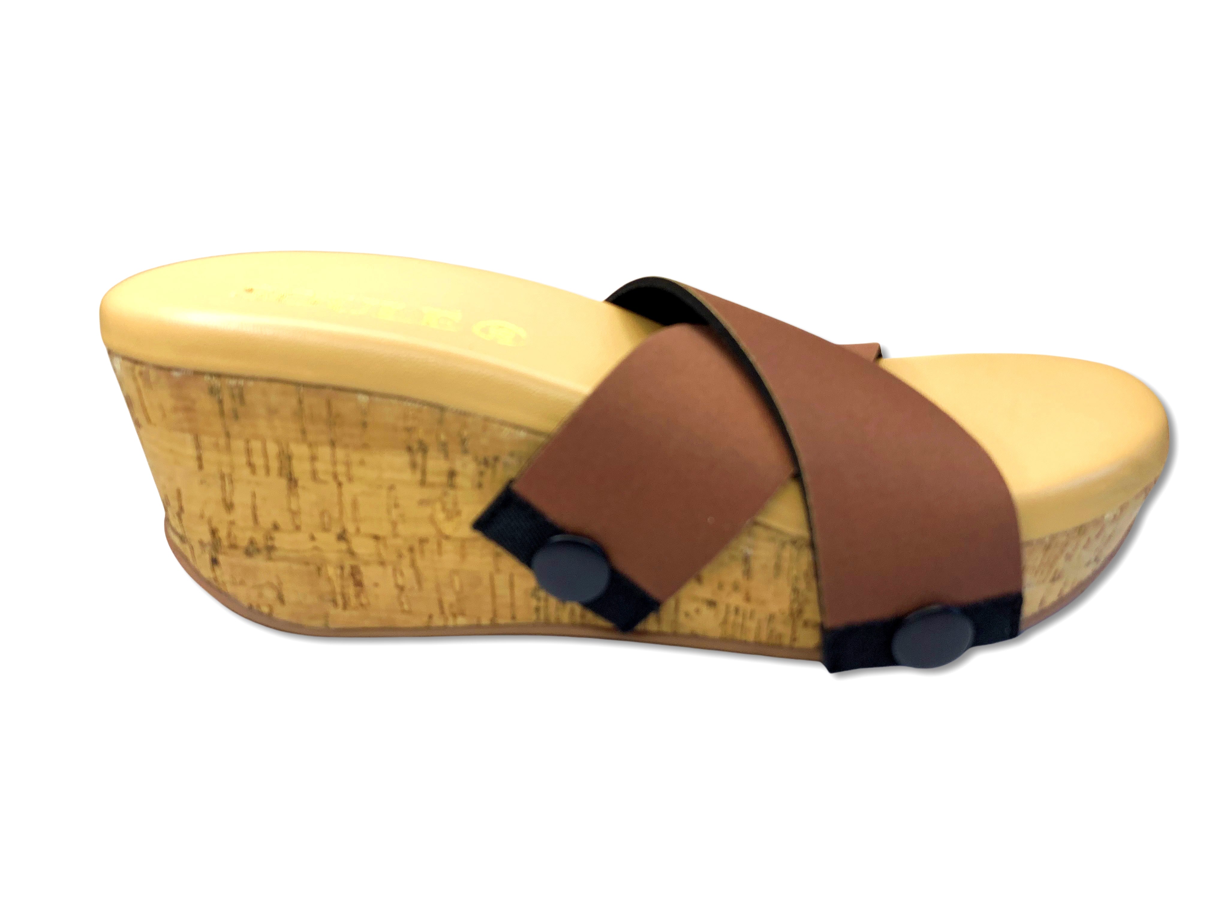 side of cork wedge slide sandals with black snap clips and rich chocolate brown criss-cross straps on white background by Soule Footwear