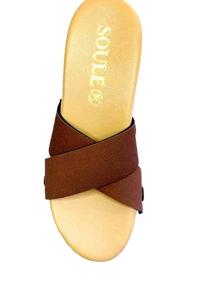 Top shot of cork wedge slide sandals with black snap clips and rich chocolate brown criss-cross straps on whitw background by Soule Footwear