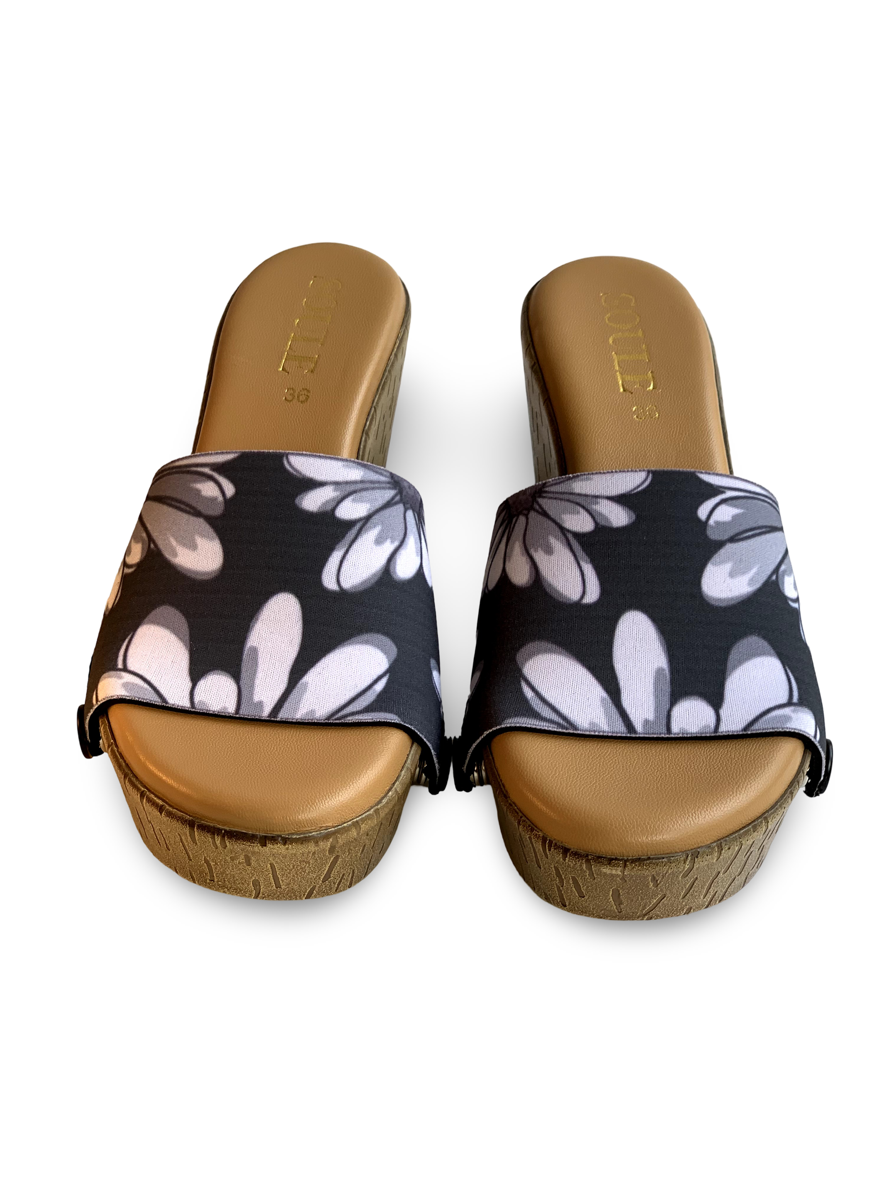 Close-up of Noir Blossom interchangeable strap on cork wedge sole by Soule Footwear on white background