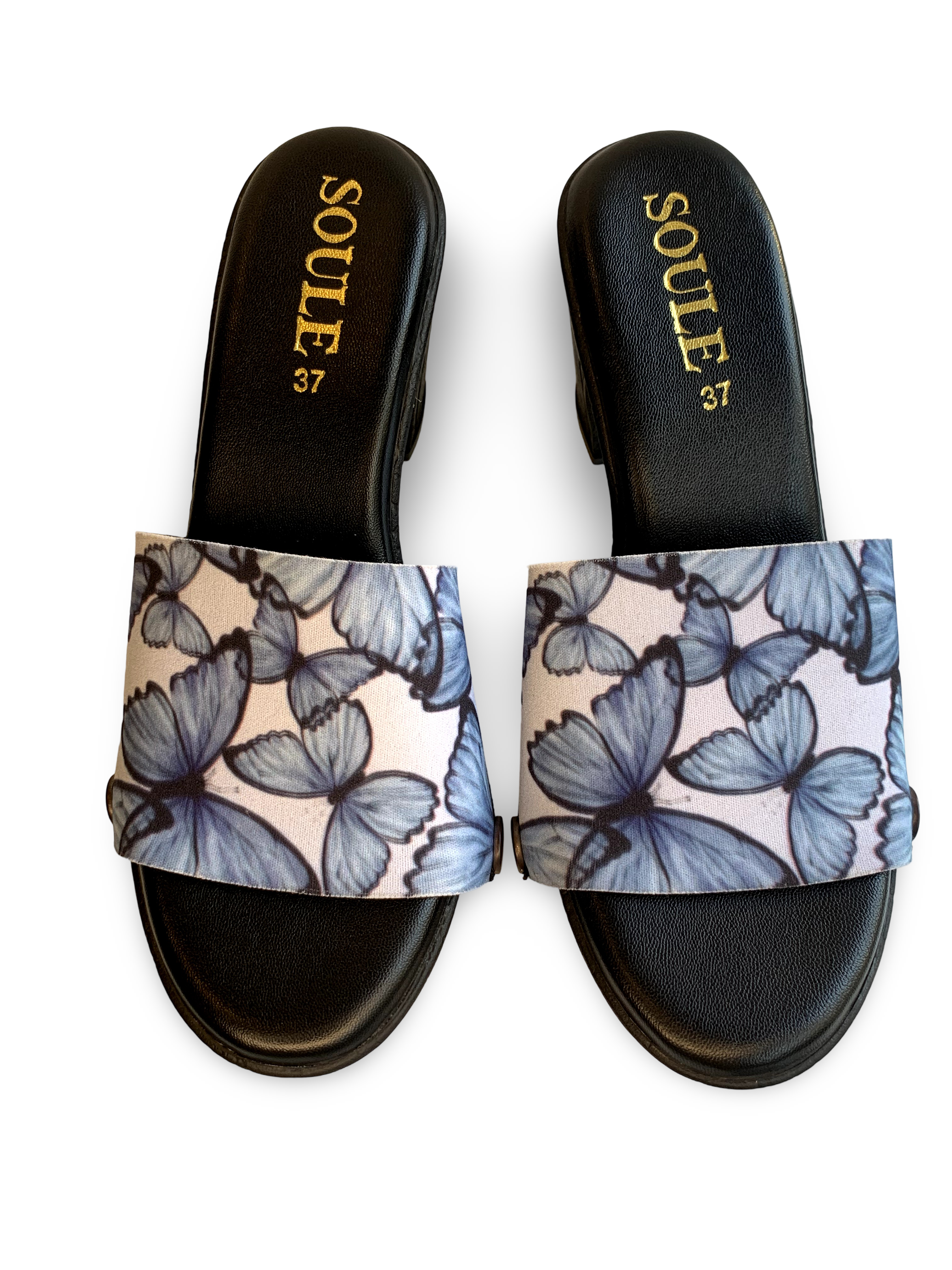 Blue Morpho snap-on shoe strap set close-up on black heel - large watercolour blue morpho butterflies on crisp white by Soule