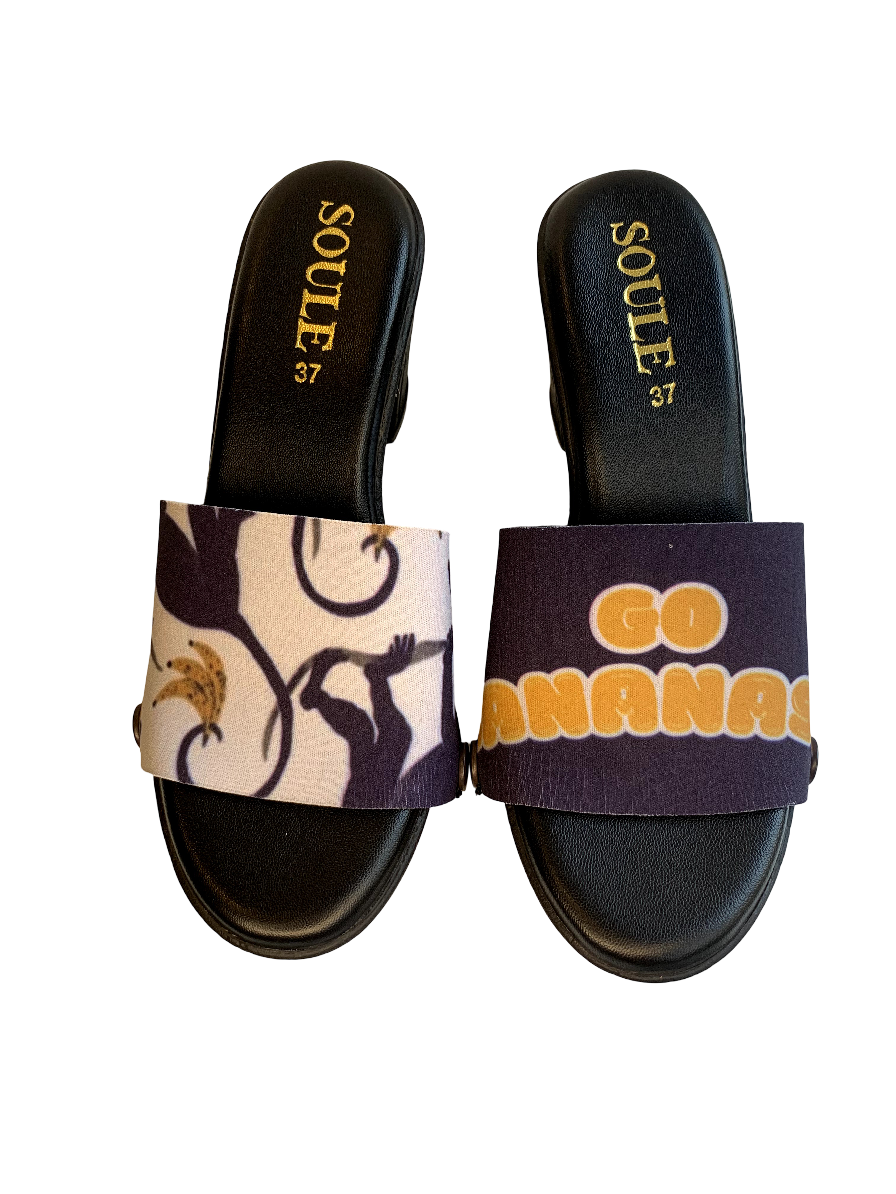 Playful Primate snap-on shoe strap set close-up on black wedge - bold navy blue monkeys and golden bananas on cream by Soule