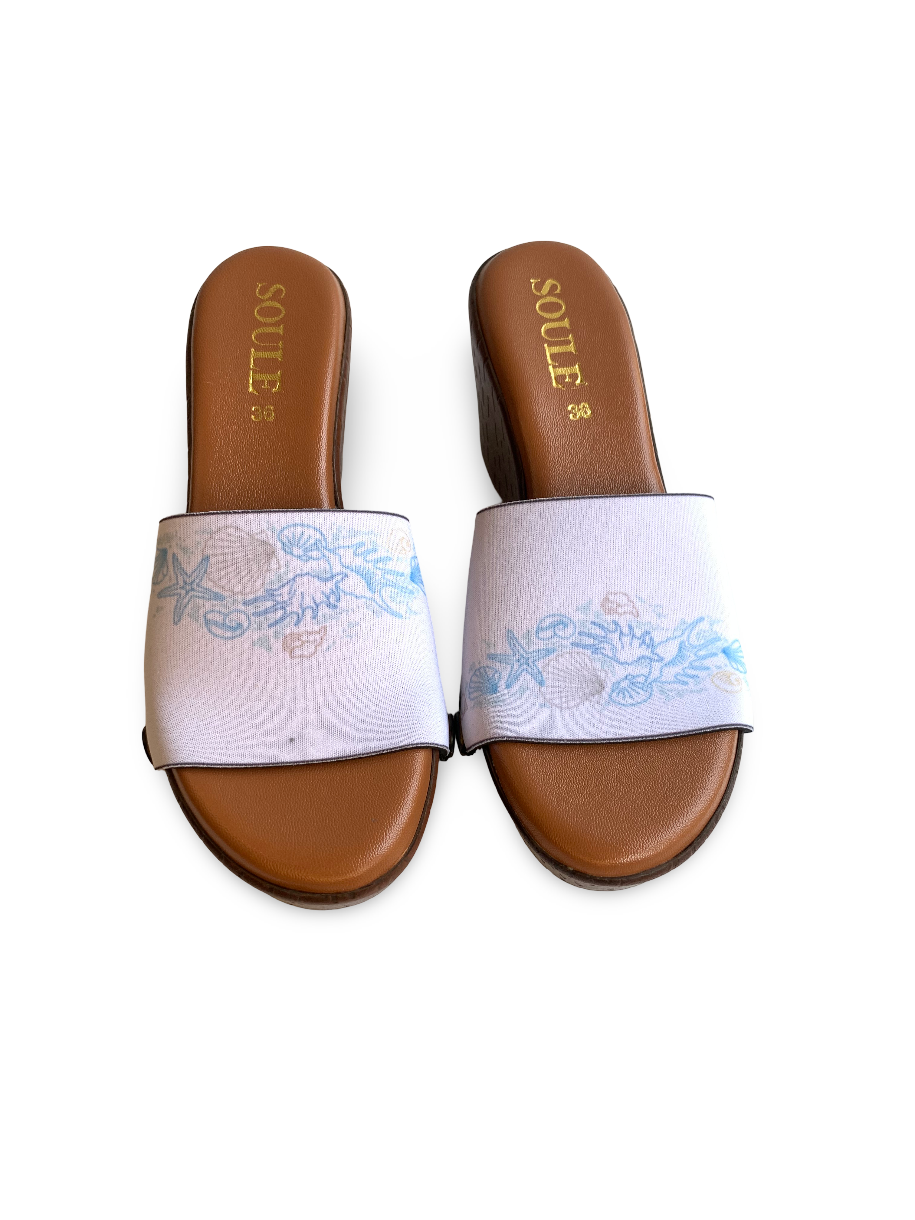 Close-up of Dreamy Ocean interchangeable strap on brown wedge sole by Soule Footwear on white background