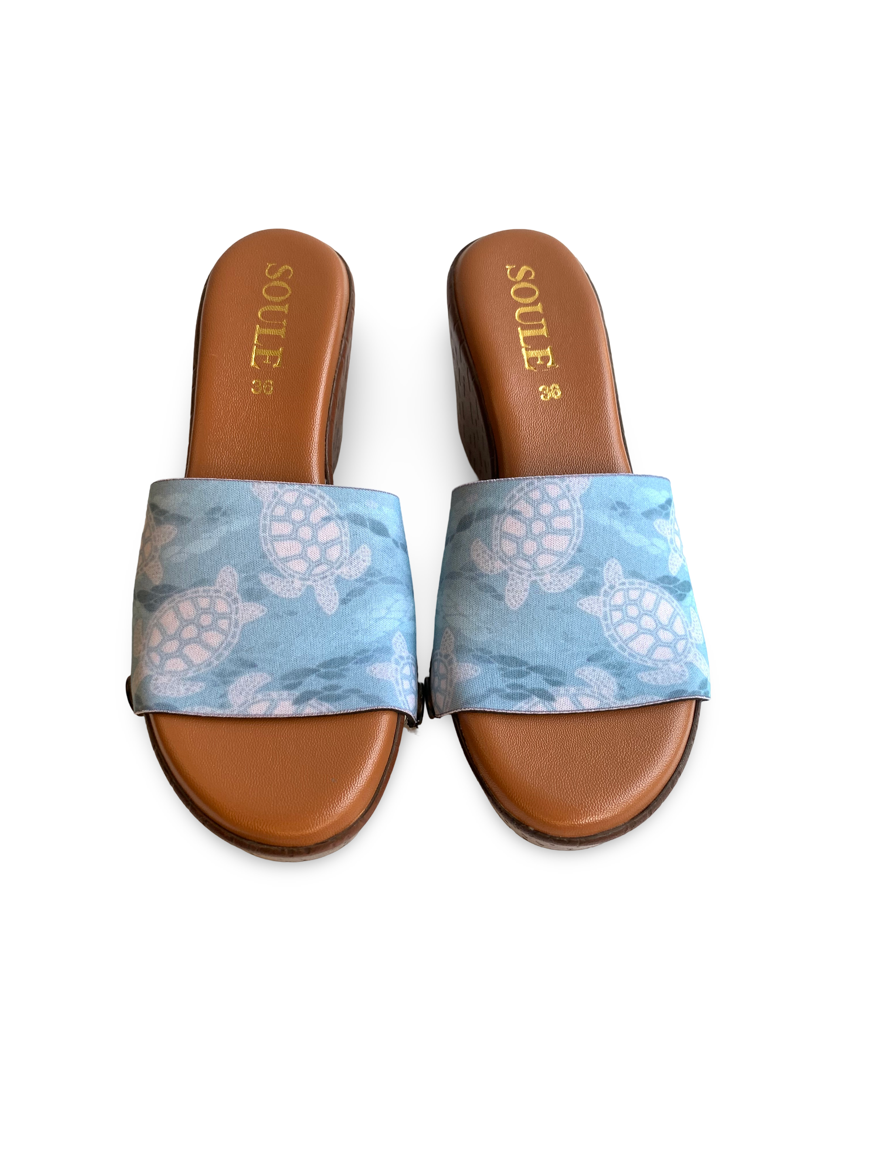  Close-up of Turtle Paradise interchangeable strap on brown wedge sole by Soule Footwear on white background