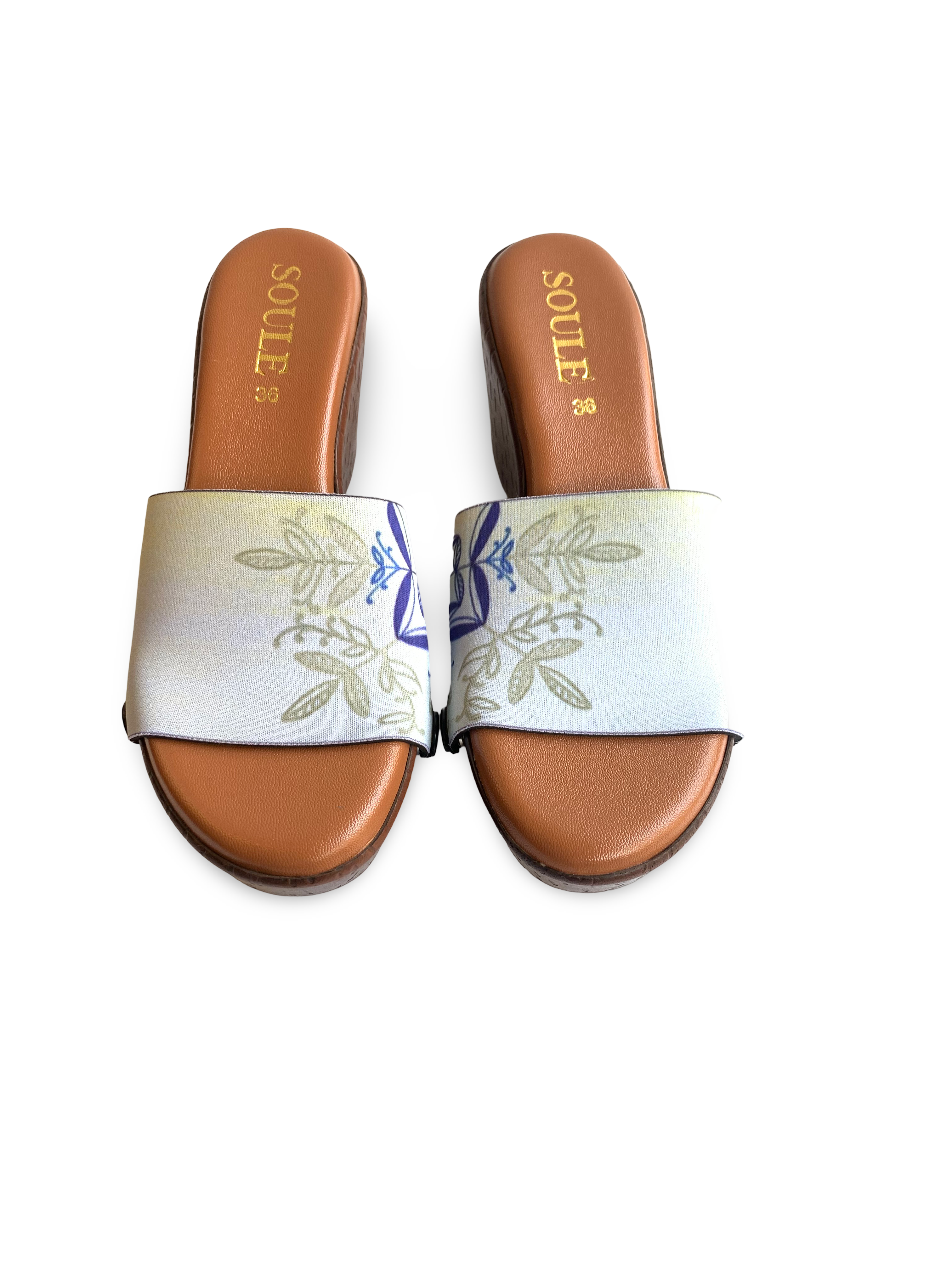 Close-up of Timeless Elegance cobalt blue Delft folk art medallion and gold olive botanical interchangeable strap on cork wedge sole by Soule Footwear 