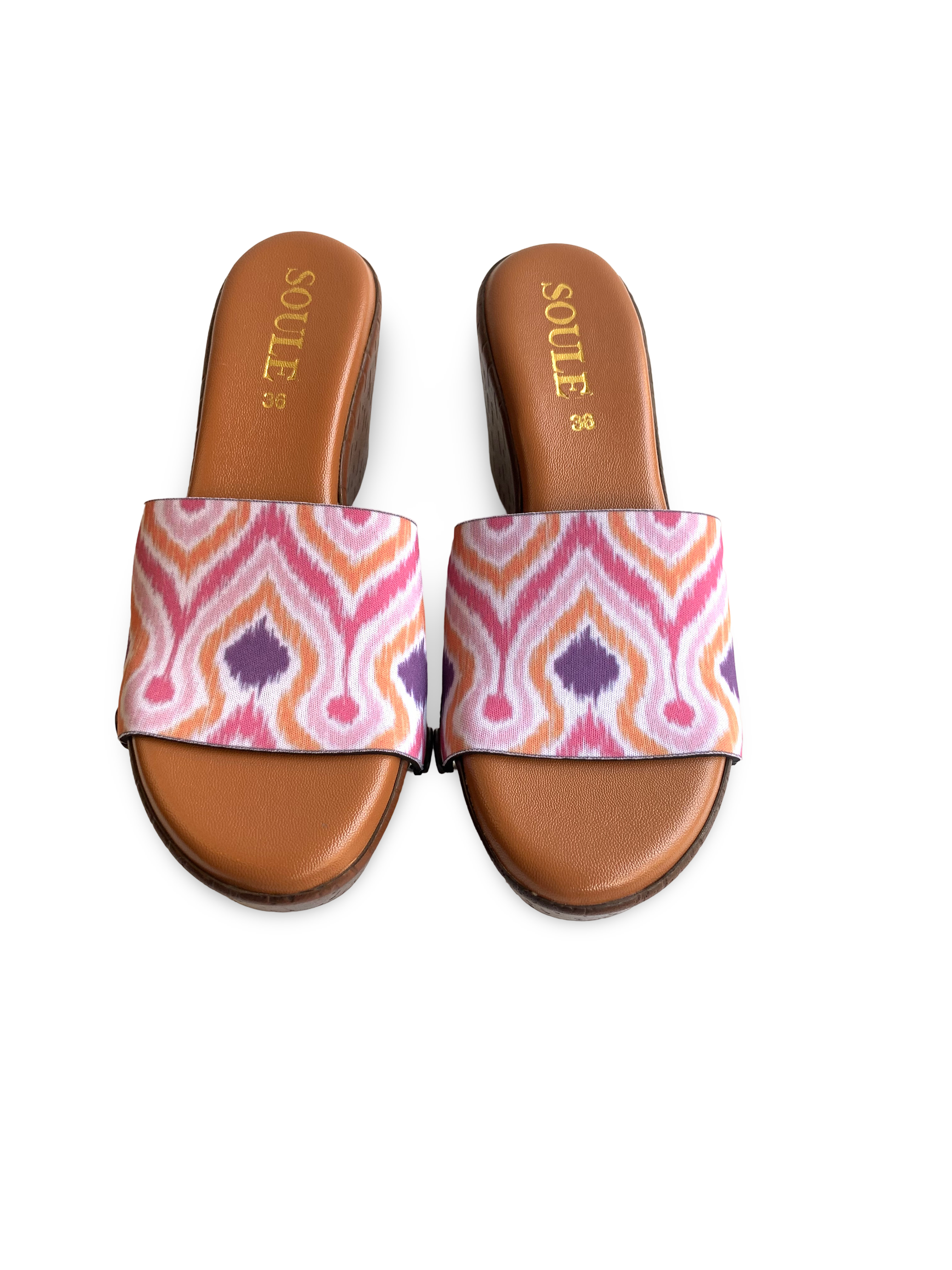 Close-up of Pochampally Ikat strap sandal — vibrant ikat flame print in orange, pink and purple on brown wedge sole with black snap closures, by Soule Footwear