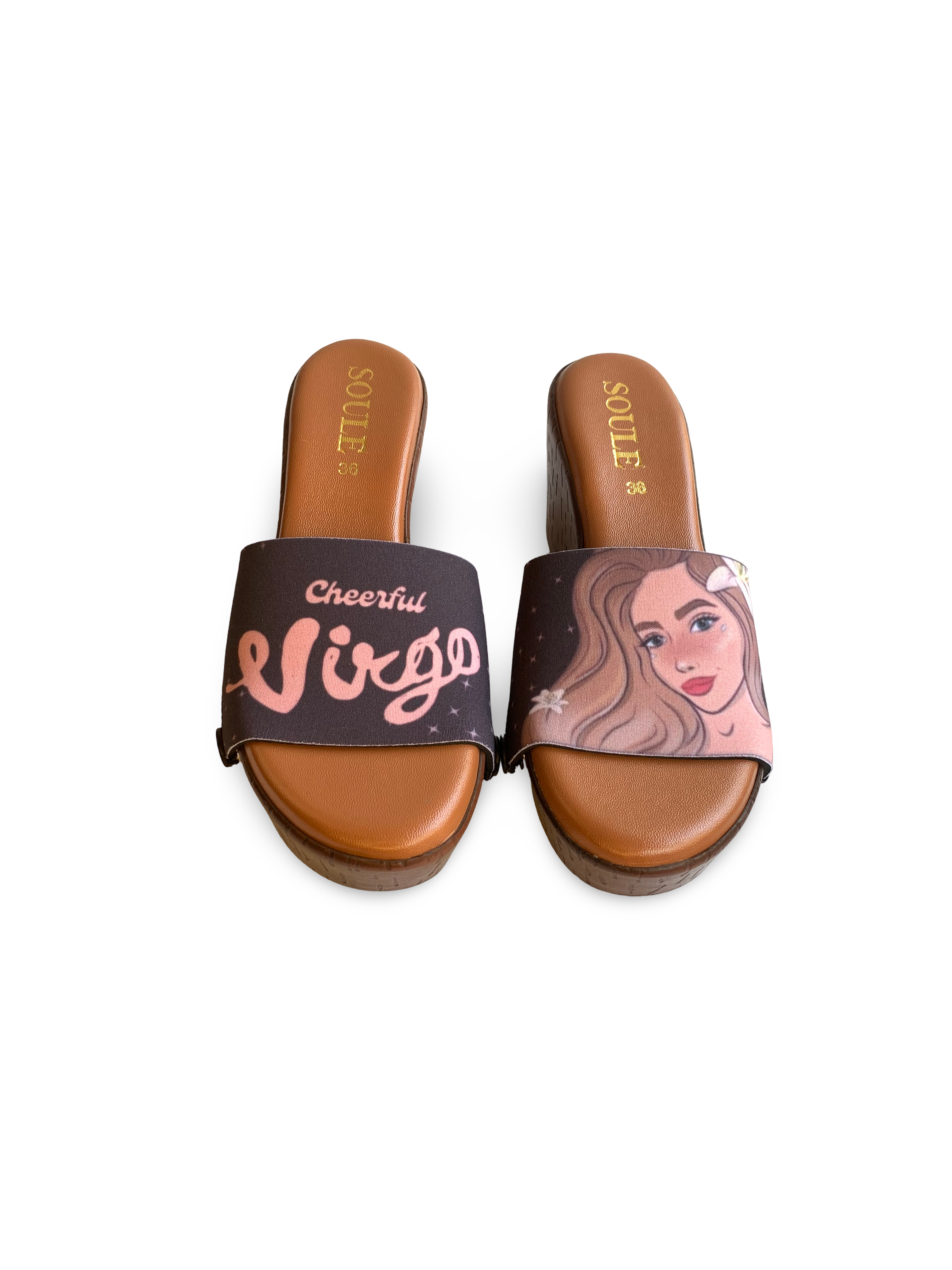 Close-up of a pair of brown sandals with interchangeable straps featuring a Virgo zodiac sign design  on brown wedge slide sandals  by Soule Footwear