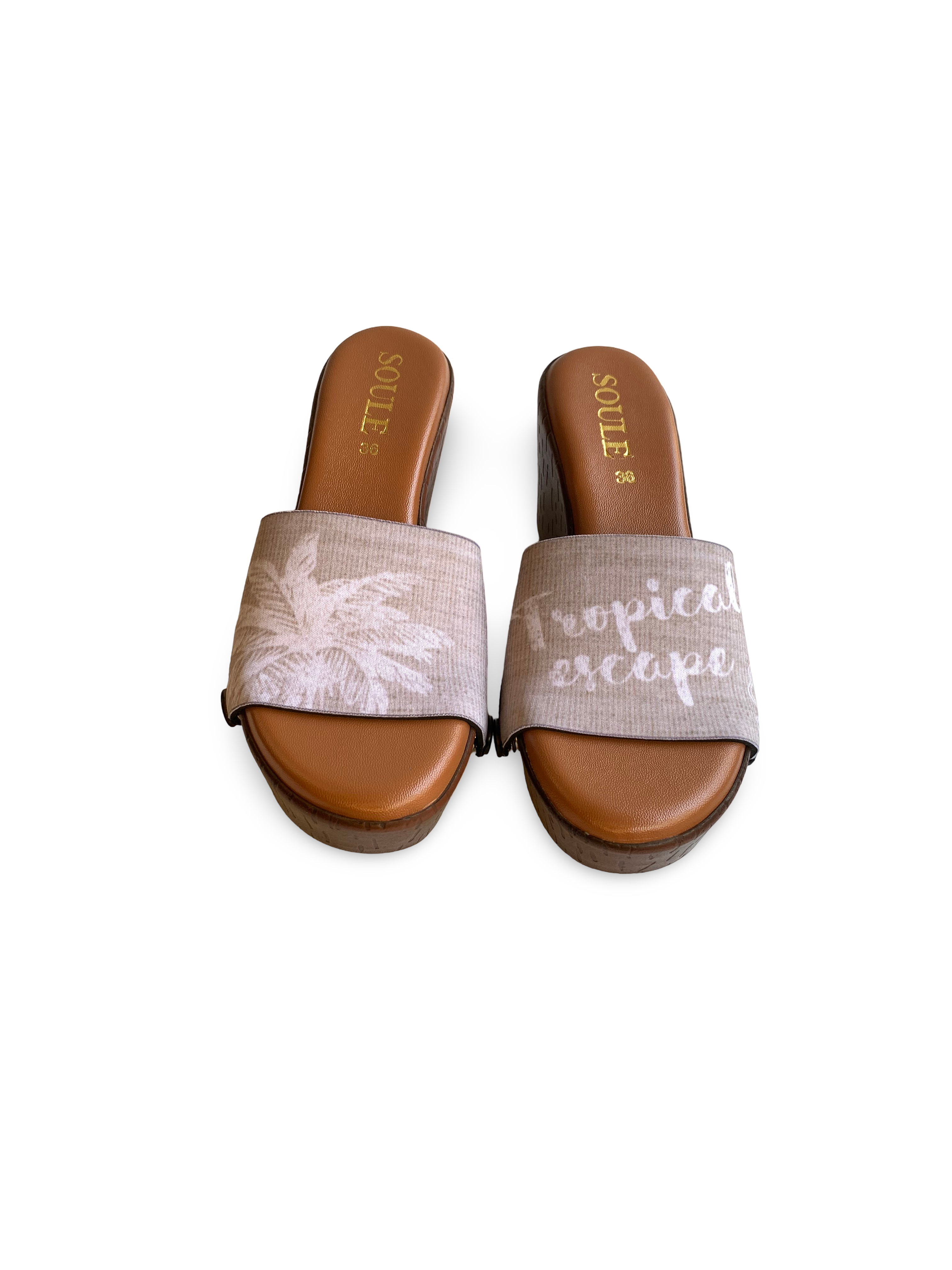 Close-up of Tropical Escape interchangeable strap on brown wedge sole by Soule Footwear on white background