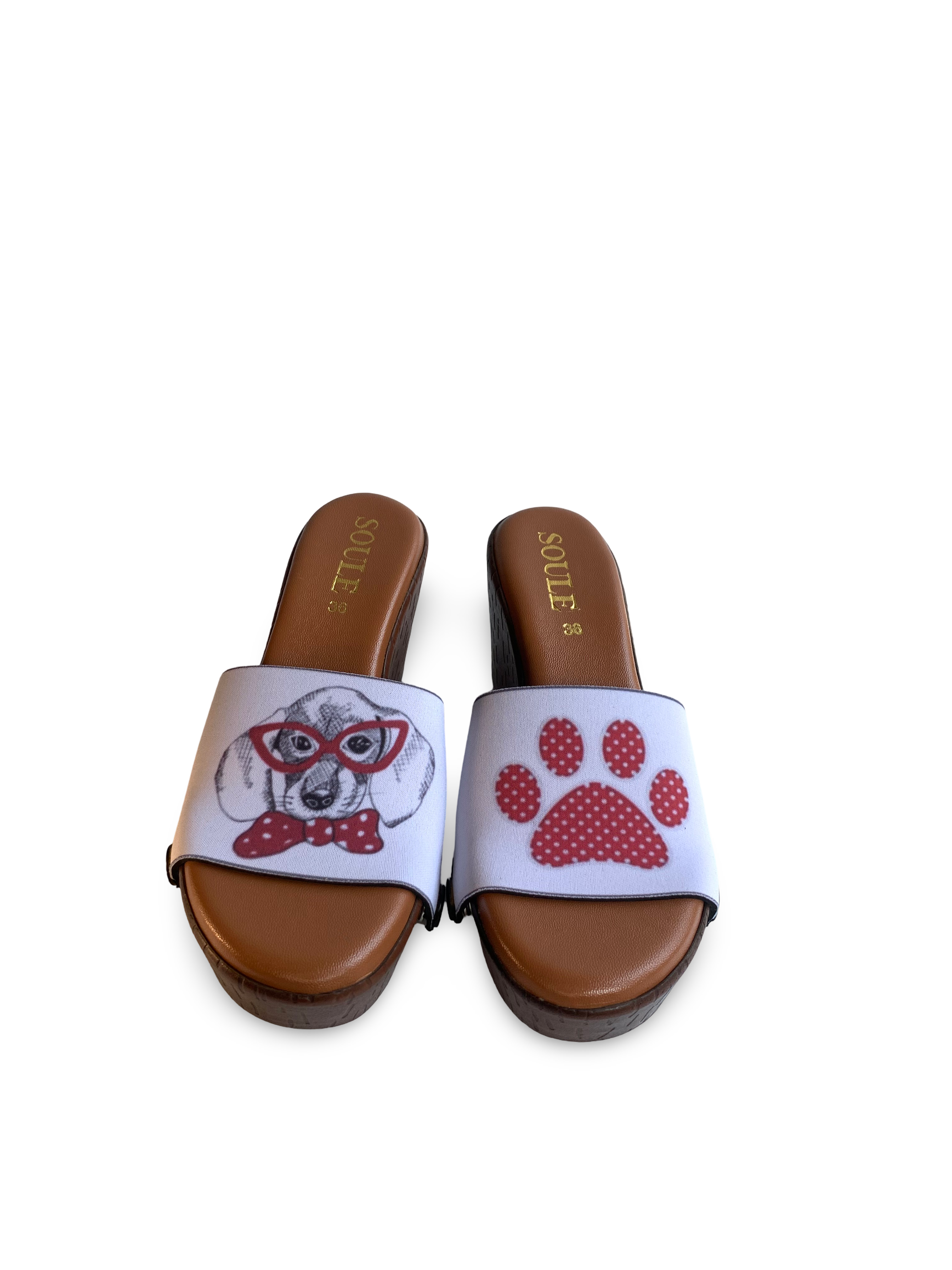 Dapper Dog snap-on shoe strap set close-up on cork wedge - illustrated dachshund in red polka dot glasses and bow tie with red paw print on white by Soule