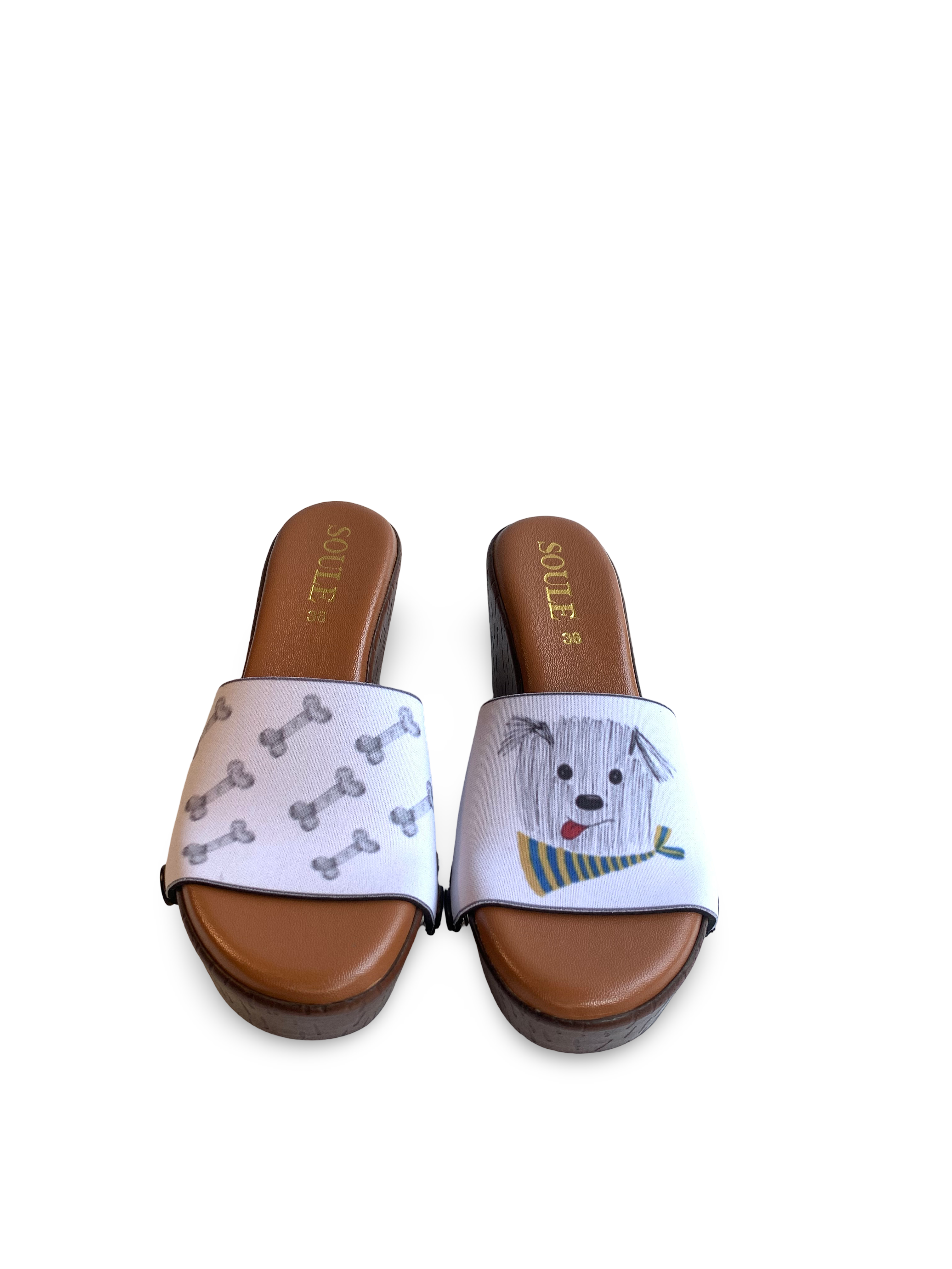 Scruffy & Bones snap-on shoe strap set close-up on cork wedge - hand-drawn scruffy dog in yellow-green scarf and dog bones on powder blue by Soule