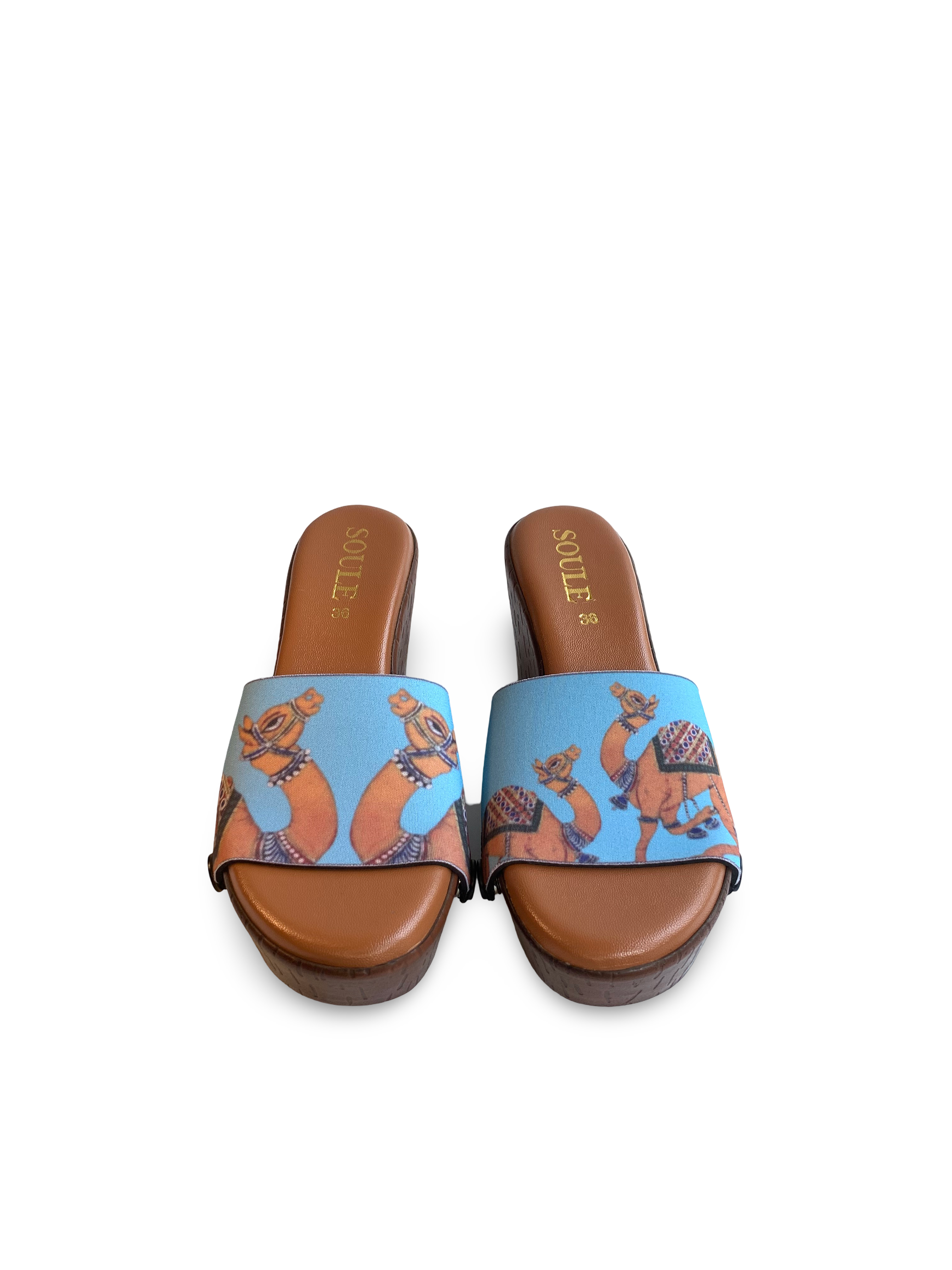 Desert Royale snap-on shoe strap set close-up on cork wedge - mirrored golden camels and dynamic camel duo on turquoise by Soule