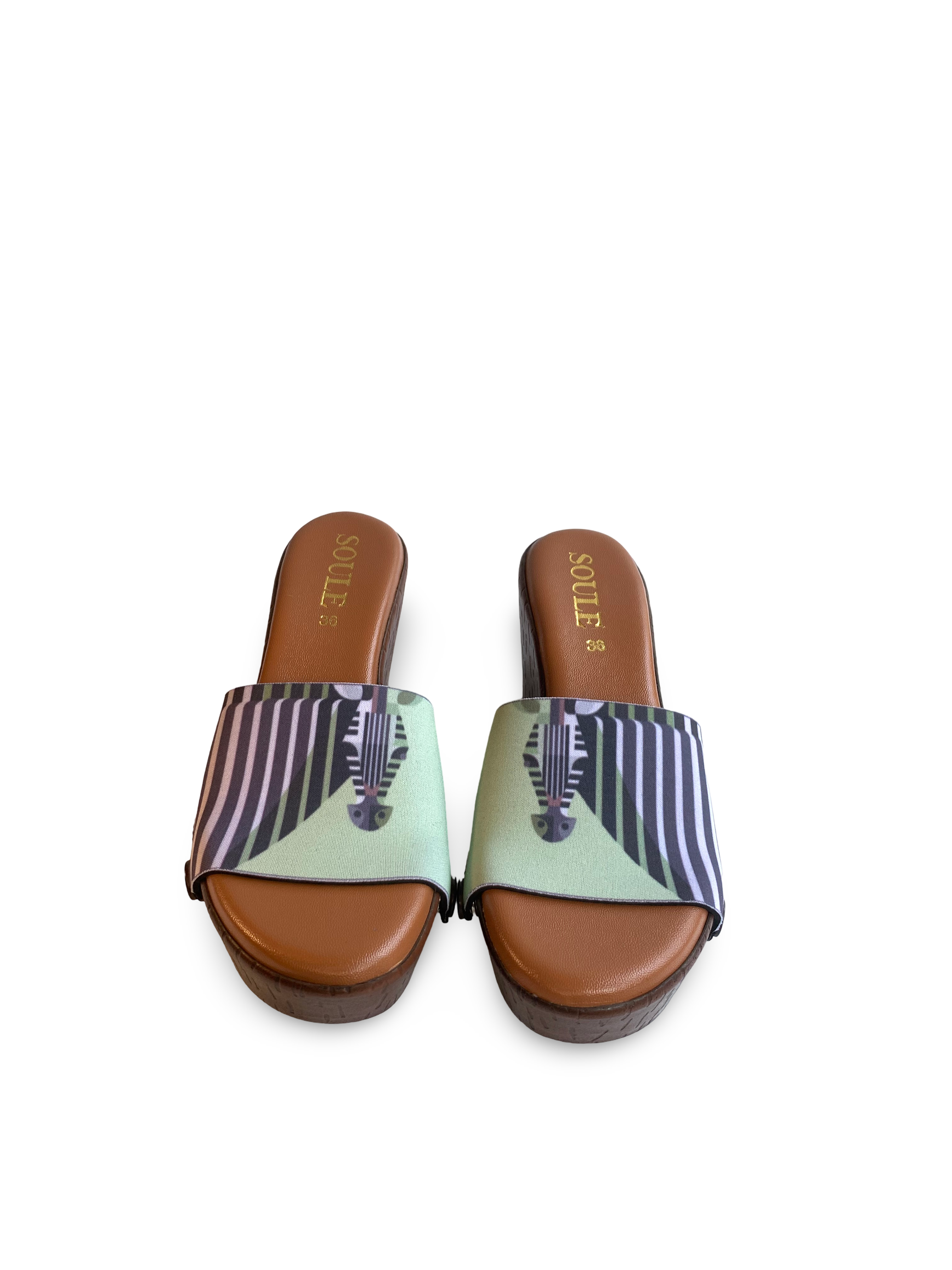 Zebra Pop snap-on shoe strap set close-up on cork wedge - graphic zebra face with radiating black and white stripes on lime green by Soule