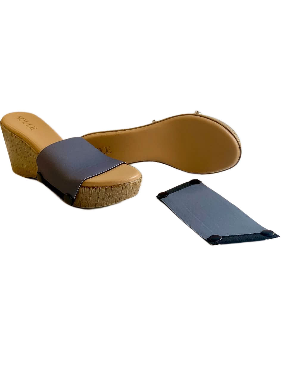 Close-up of plain grey snap-on shoe strap on Soule cork wedge platform sole with black snap buttons