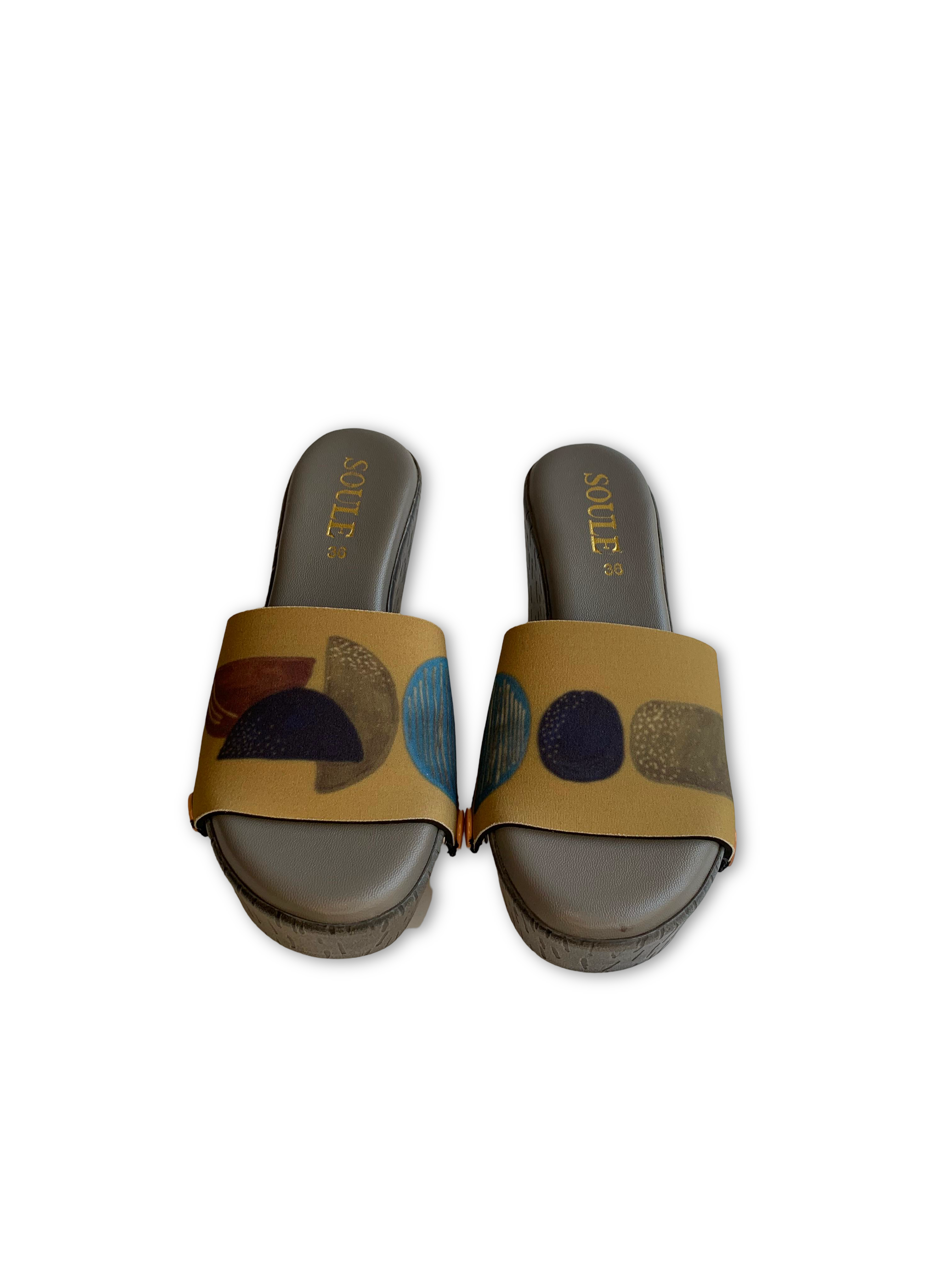 Bauhaus Circle snap-on shoe strap close-up on cork wedge - mustard yellow with navy and terracotta circles by Soule