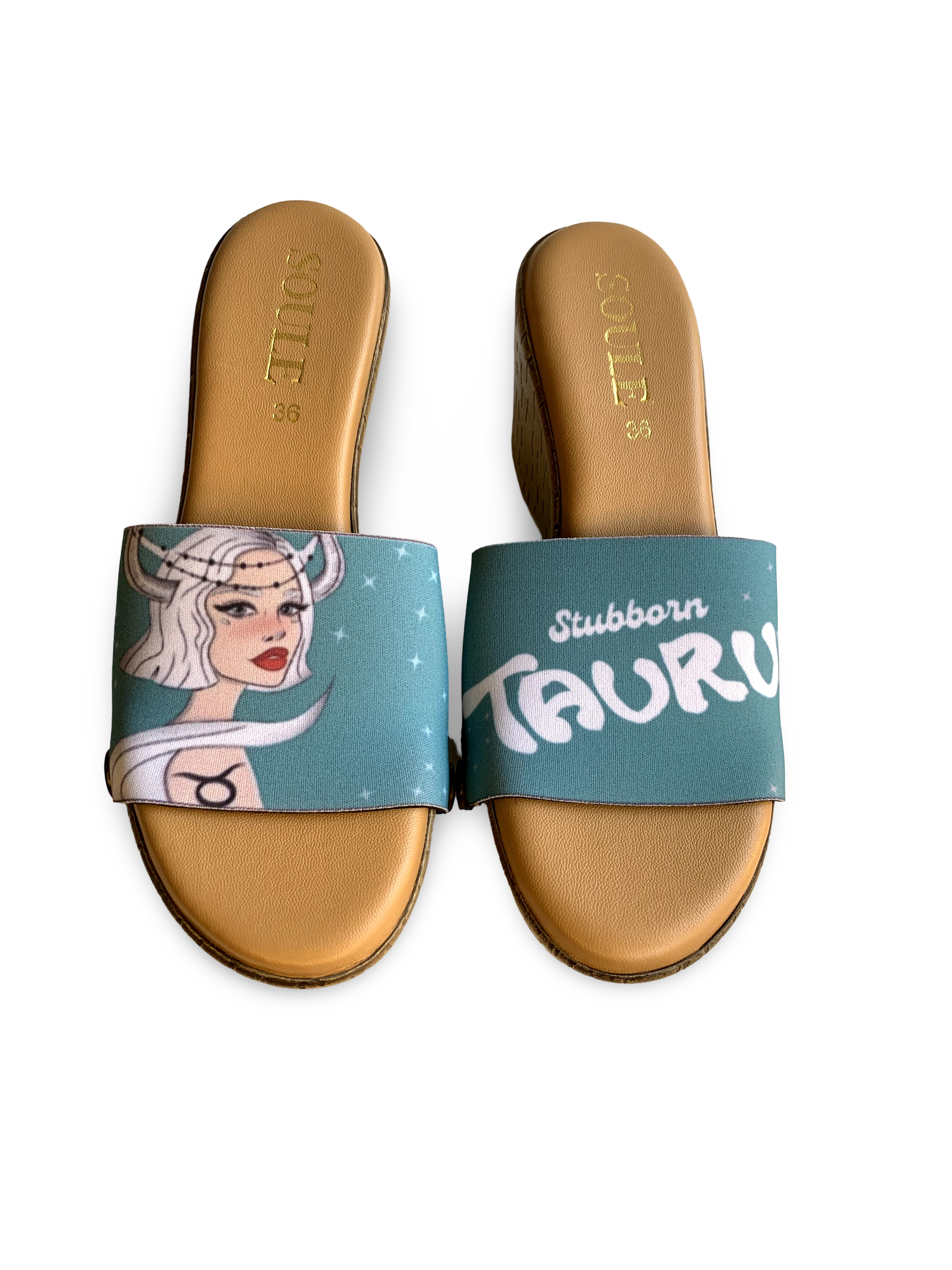 Pair of brown sandals with 'Stubborn Taurus' design on a white background
