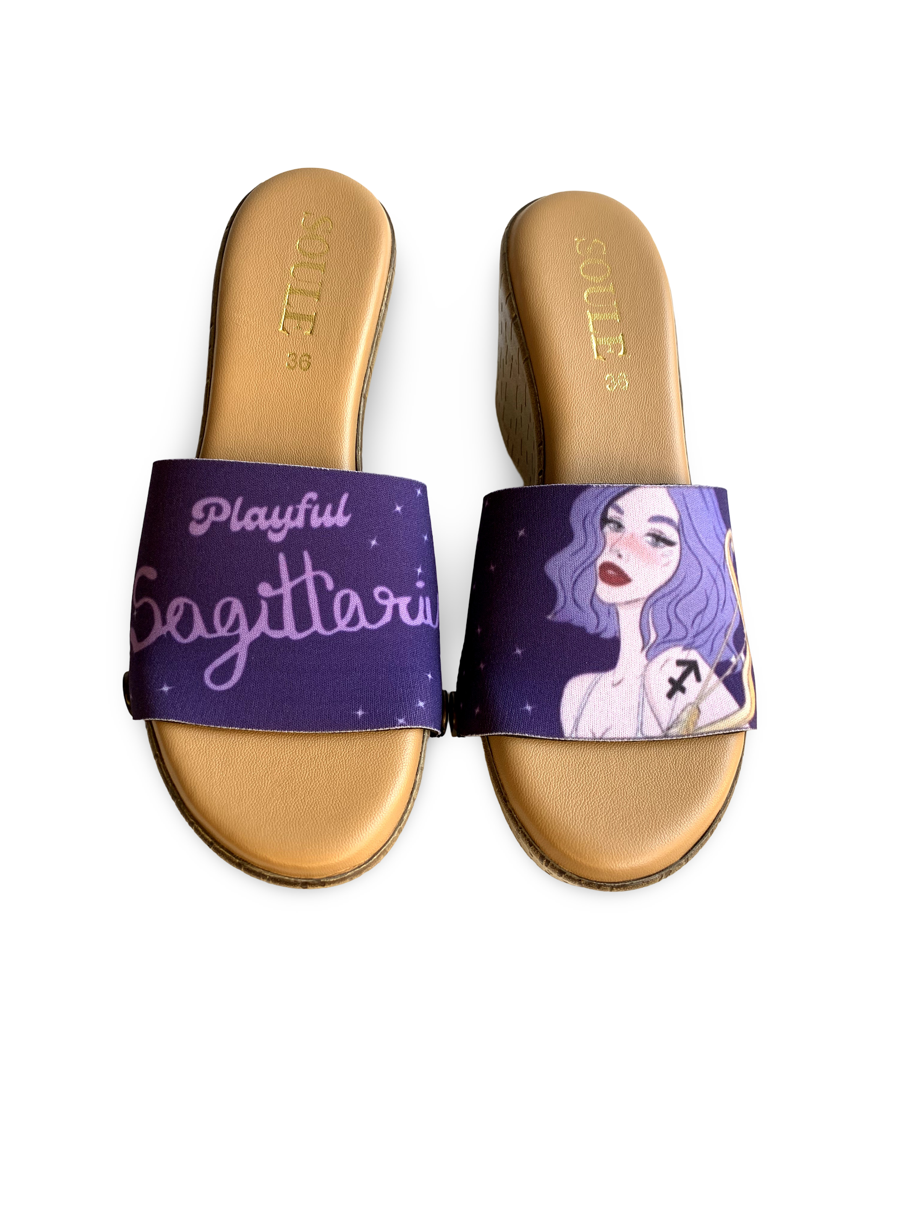 Close-up of brown wedge slide sandals with black snap clips and deep purple Playful Sagittarius zodiac strap with stars  by Soule Footwear